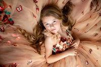 Young girl wearing a floral sequin gown for a flower girl photoshoot

