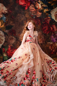 A child twirling in the gown in a field of wildflowers at golden hour — soft sunlight, dreamy blur.

