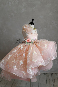 "The sparkling butterfly embroidery on the Anastasia gown glistening under soft lighting, perfect for a magical photoshoot."

