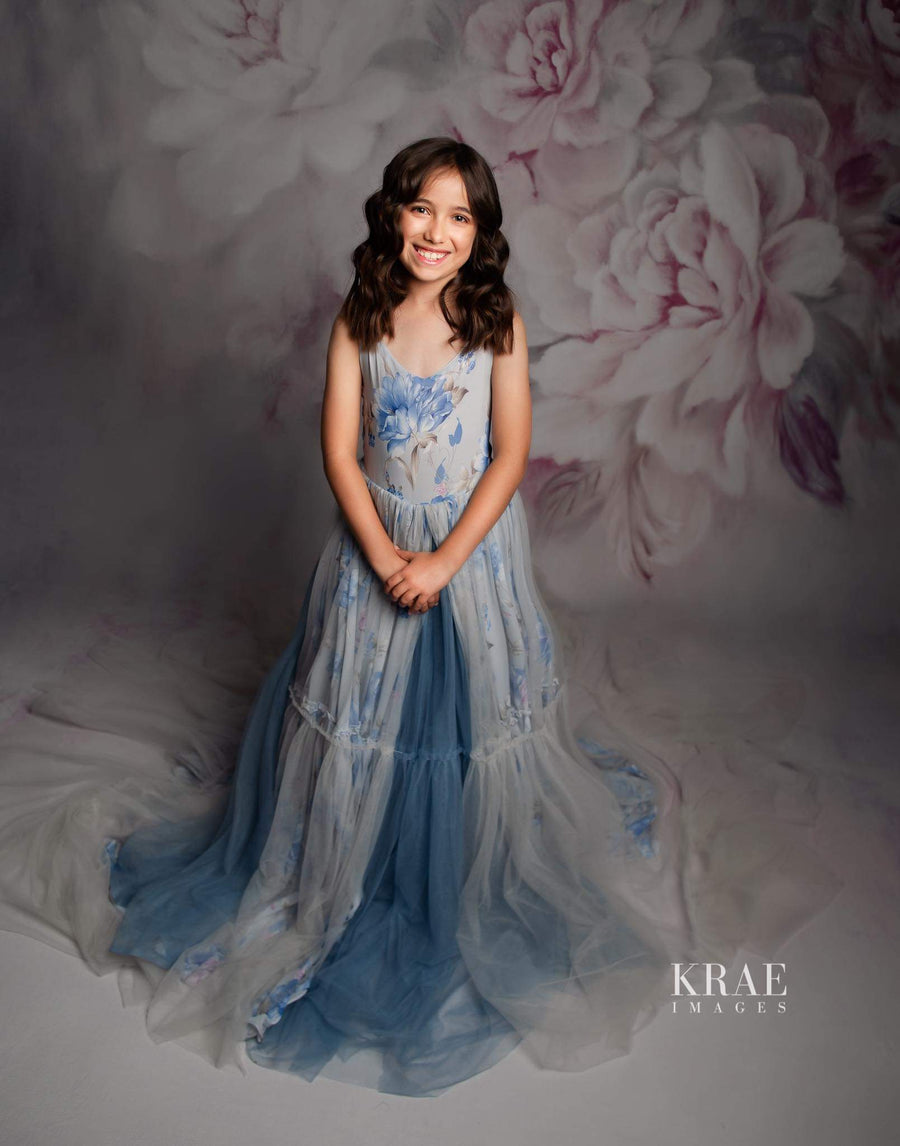 Girl twirling in Hillary gown with dramatic trailing skirt.

